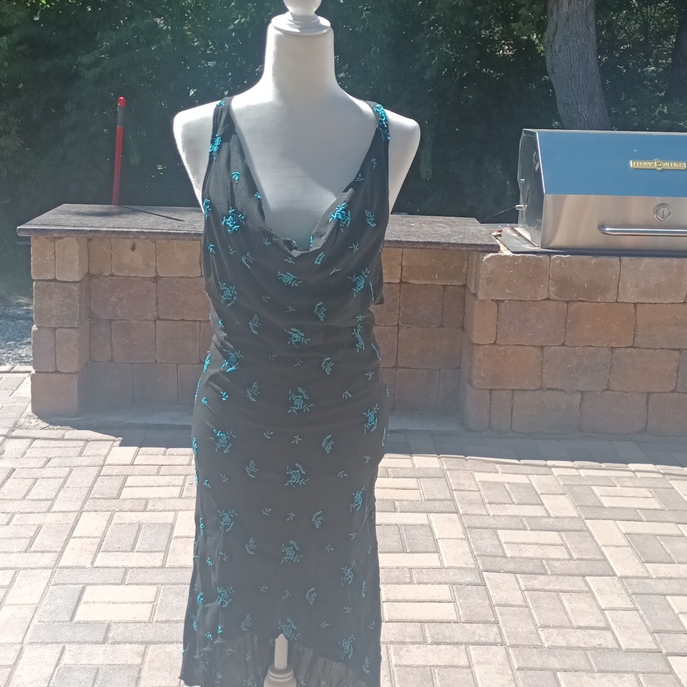 High low, teal flowers black background. Open back with criss-cross straps.